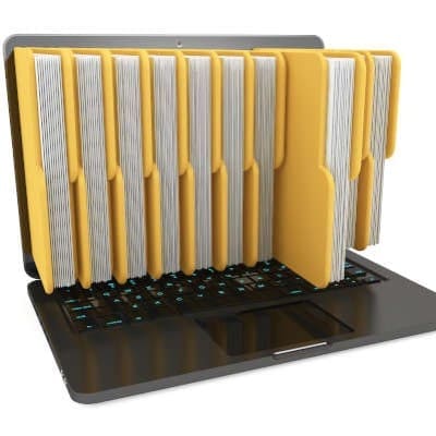 Full yellow file folders appear to be sticking out of a laptop screen