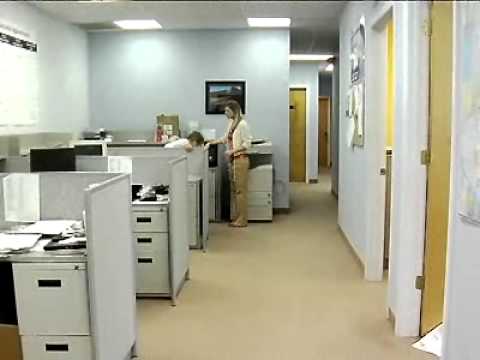 Video Image: Cubicle office set up, woman at copier